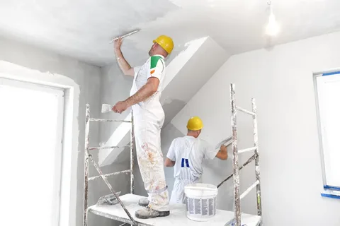 Men Plastering the walls of the house