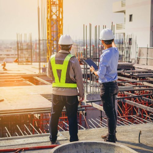 Two men discussing things while standing at the site