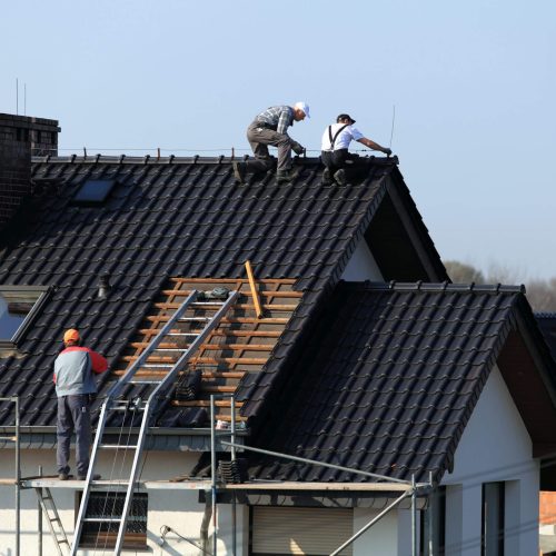 workers reapiring the roof